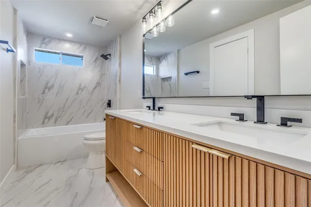 a bathroom with a tub sink and mirror