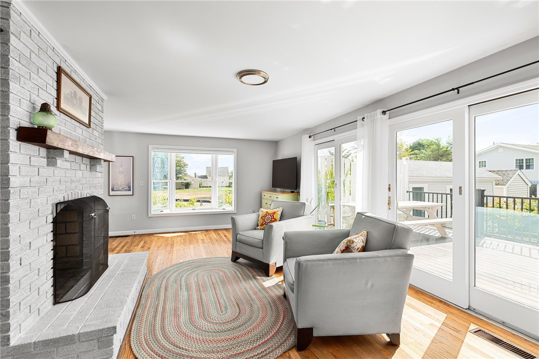 41 8th Avenue Warwick, RI 02886 - Photo 21 of 49 family room with access to side porch and rear dedk; double sided fireplace