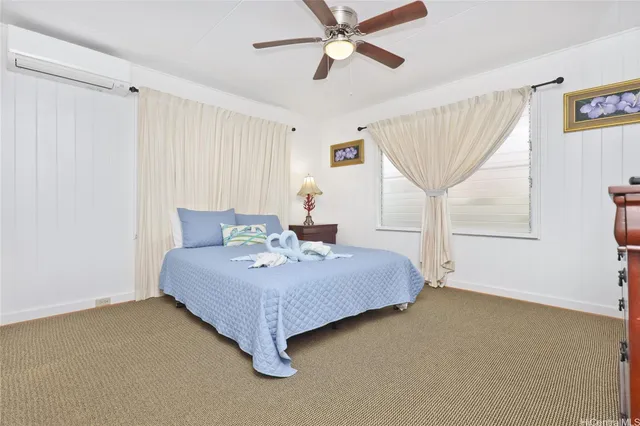 a spacious bedroom with a bed and a chandelier