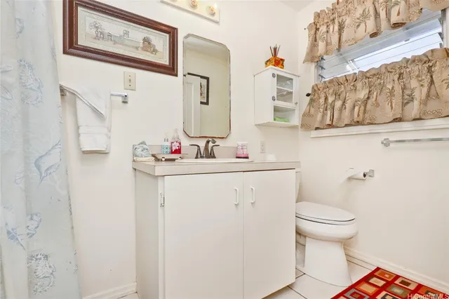 a bathroom with a sink toilet and mirror