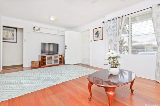 a living room with furniture and a flat screen tv