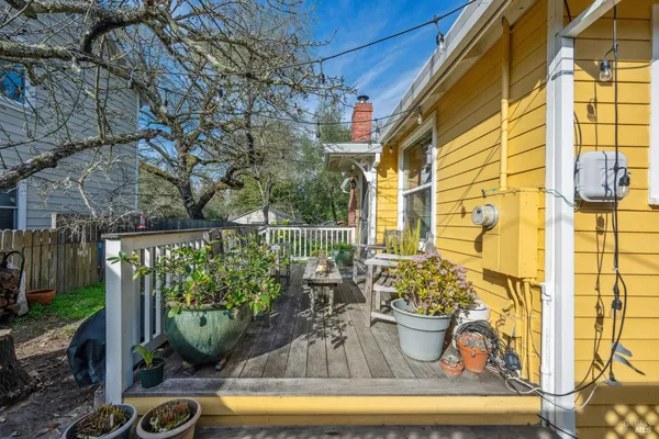a view of a patio with table and chairs and wooden floor