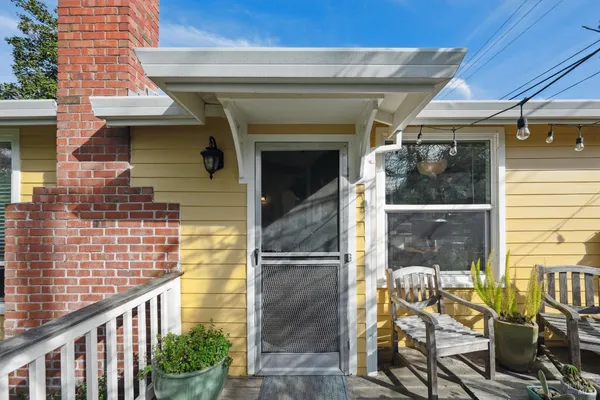 a view of a patio with couches chairs and wooden floor