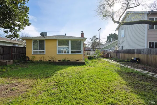 a backyard of a house with outdoor seating