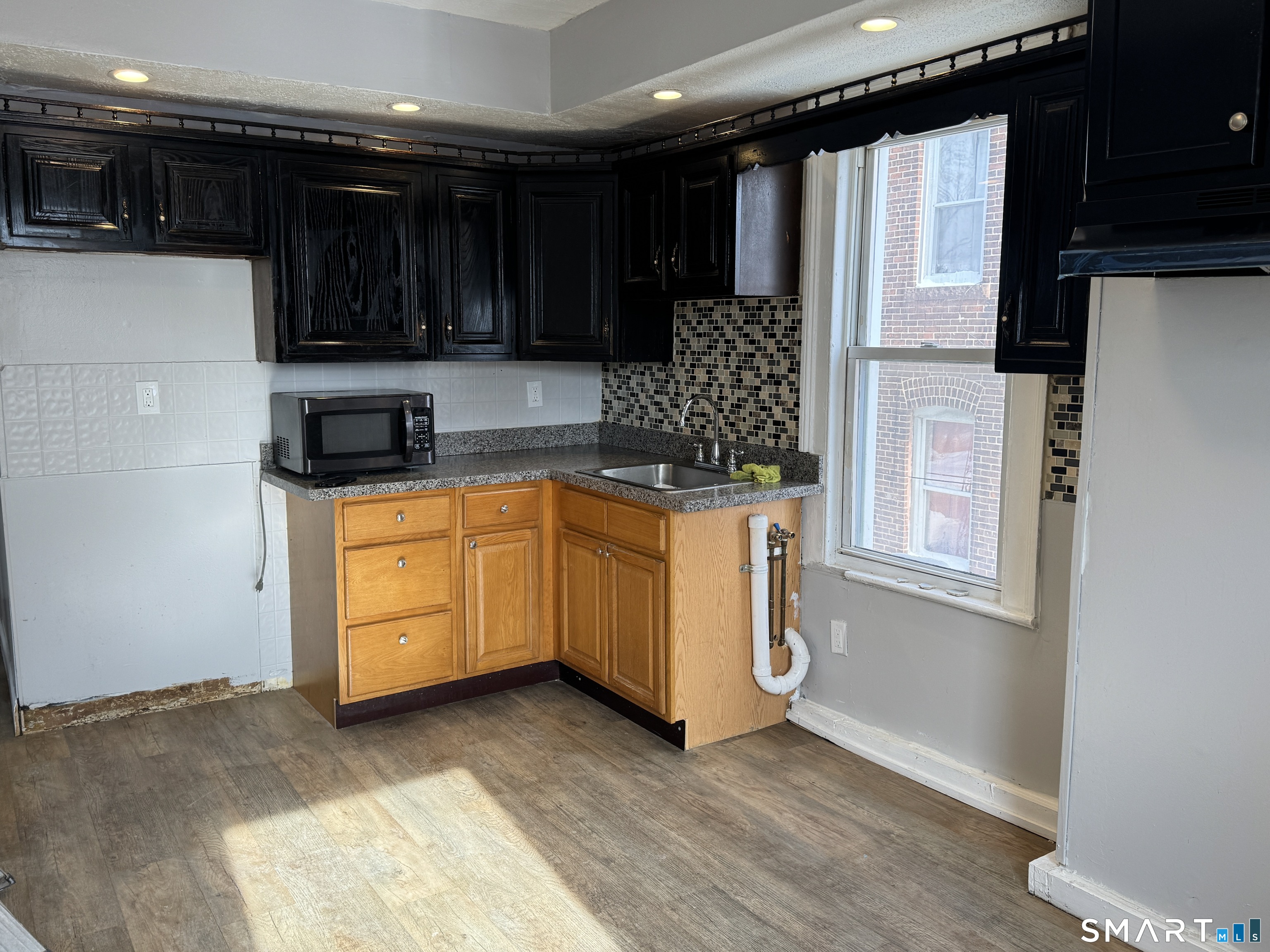 107 Hamilton Street, Unit 2 Hartford, CT 06106 - Photo 2 of 9 a kitchen with granite countertop a stove a sink and a refrigerator