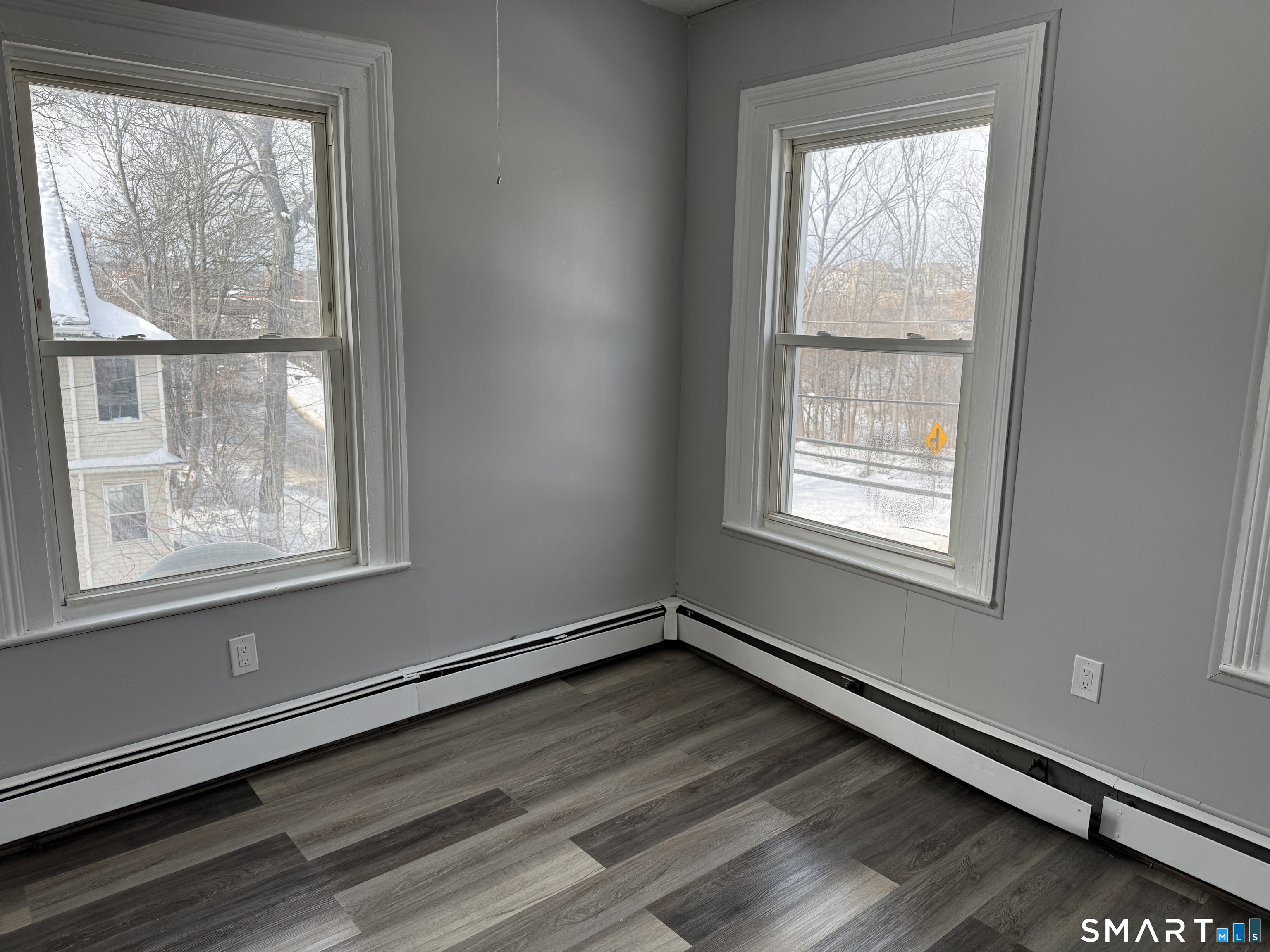 107 Hamilton Street, Unit 2 Hartford, CT 06106 - Photo 8 of 9 an empty room with wooden floor and windows