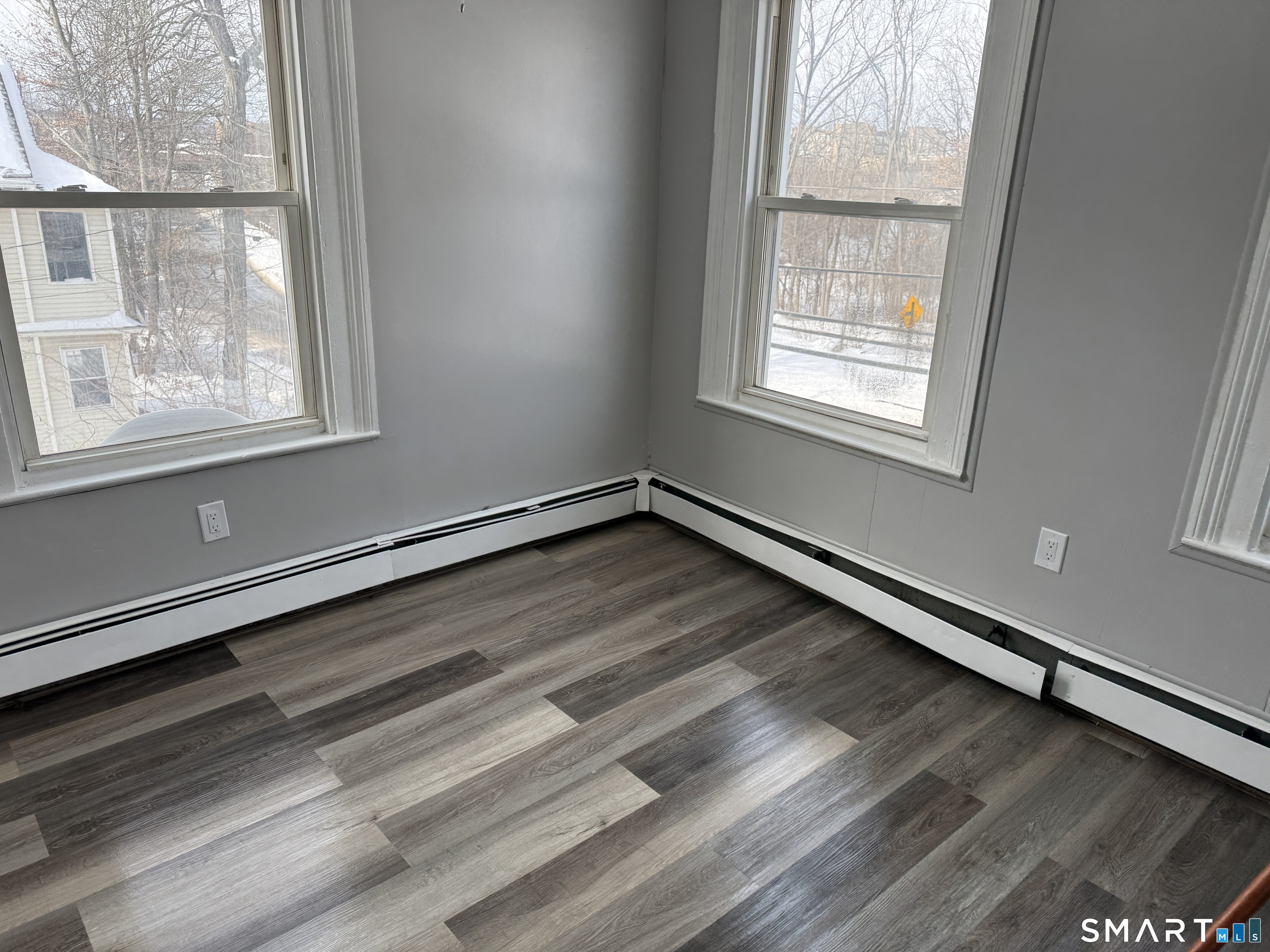 107 Hamilton Street, Unit 2 Hartford, CT 06106 - Photo 9 of 9 an empty room with wooden floor and windows