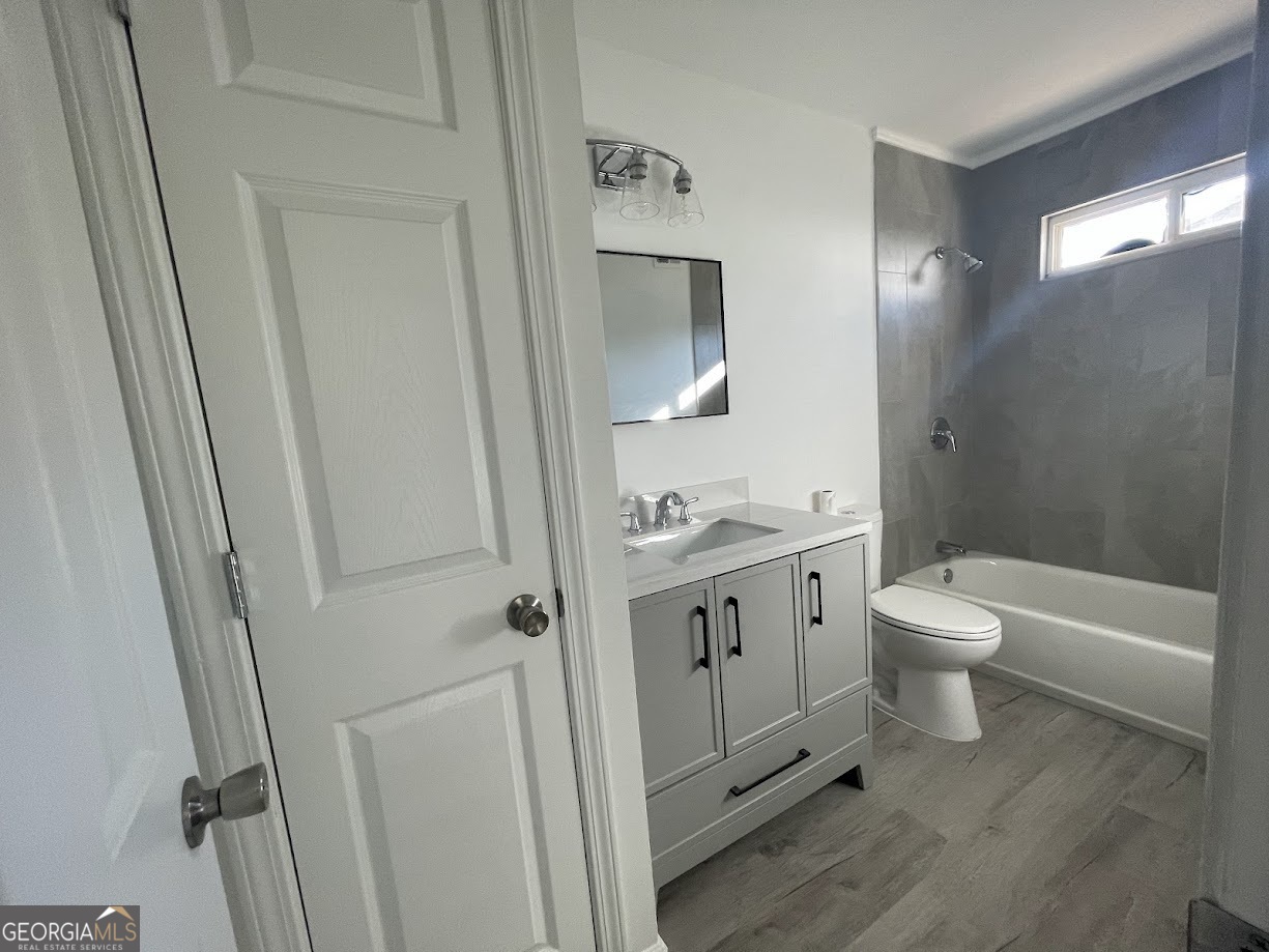 405 Fairburn Road Southwest, Unit 135 Atlanta, GA 30331 - Photo 5 of 10 a bathroom with a granite countertop sink toilet a shower and a mirror