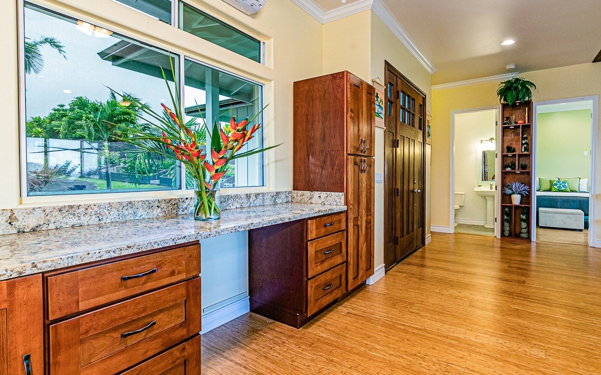 28-256 Akaka Falls Road Honomu, HI 96728 - Photo 14 of 26 a kitchen with stainless steel appliances granite countertop a refrigerator and a sink