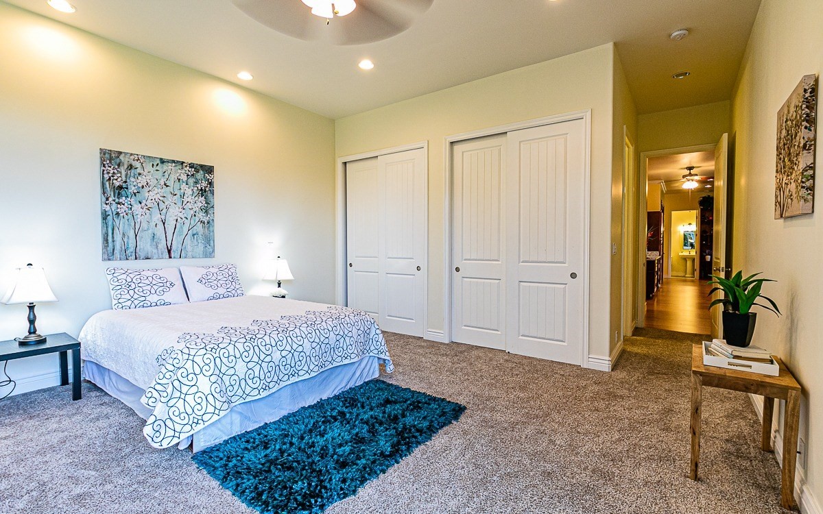 28-256 Akaka Falls Road Honomu, HI 96728 - Photo 21 of 26 a bedroom with a large bed and painting on the wall