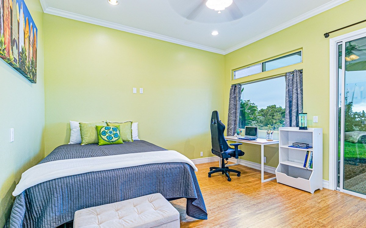 28-256 Akaka Falls Road Honomu, HI 96728 - Photo 25 of 26 a bedroom with a bed and wooden floor