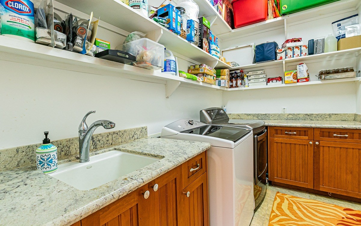 28-256 Akaka Falls Road Honomu, HI 96728 - Photo 26 of 26 a kitchen with stainless steel appliances granite countertop a sink a stove and cabinets