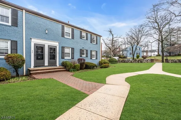 a view of a brick house with a yard