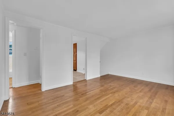 a kitchen with stainless steel appliances granite countertop a sink window and cabinets