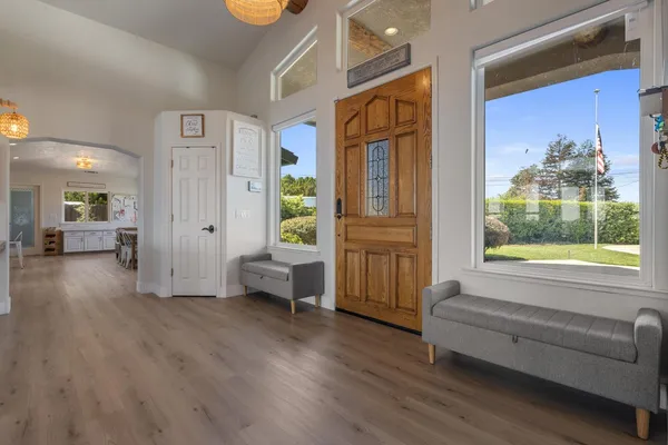 a kitchen with white cabinets and window