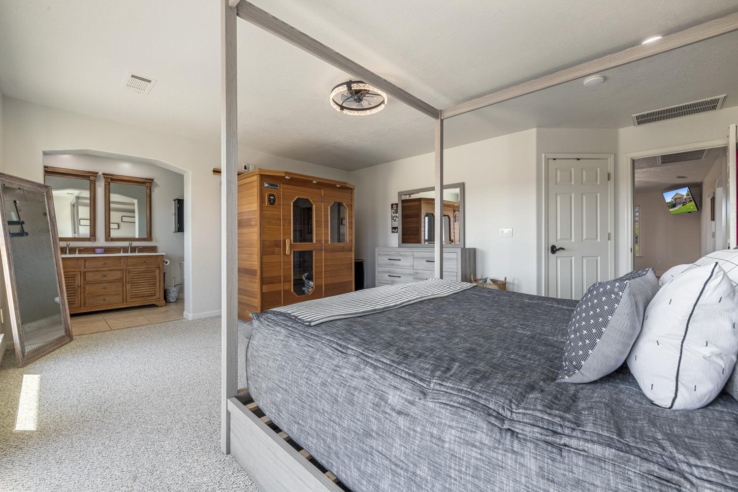 8300 Jantzen Road Modesto, CA 95357 - Photo 22 of 73 a spacious bedroom with a bed and a large mirror on a dresser