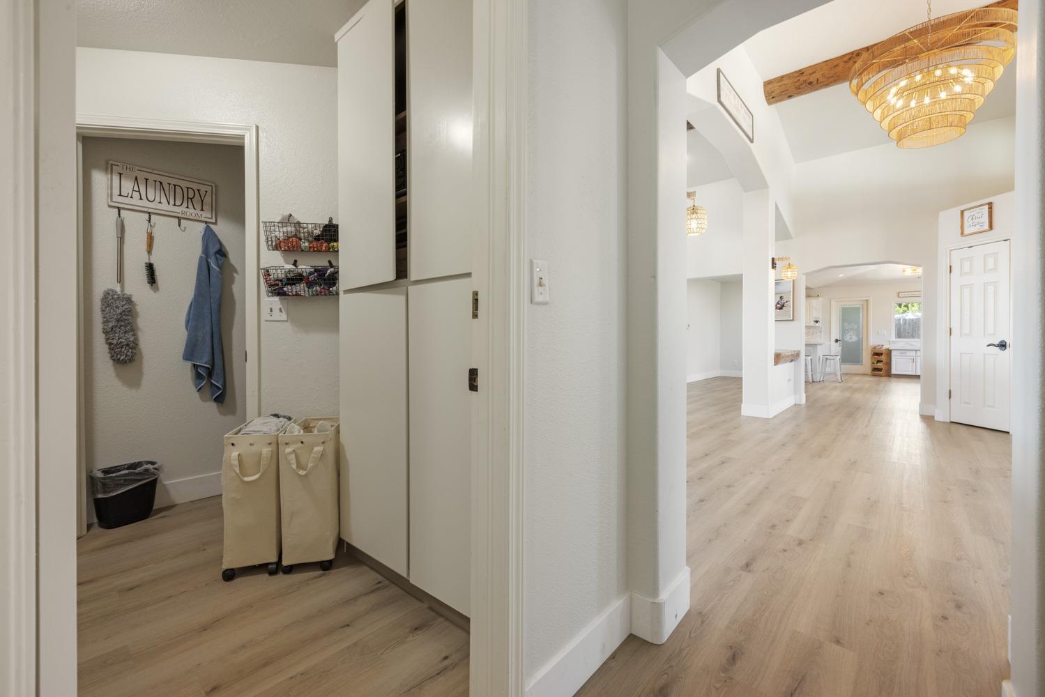 8300 Jantzen Road Modesto, CA 95357 - Photo 47 of 73 a view of a hallway with wooden floor and a living room