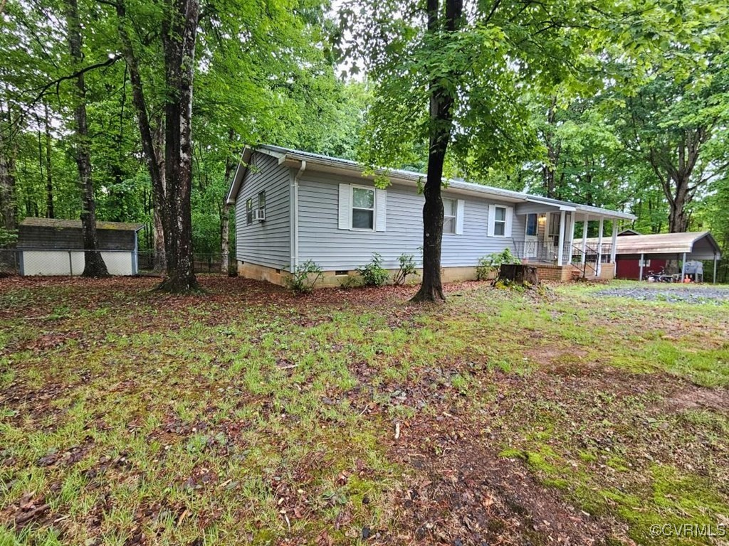 2626 Troublesome Creek Road Dillwyn, VA 23936 - Photo 2 of 24 a view of a house with backyard and trees
