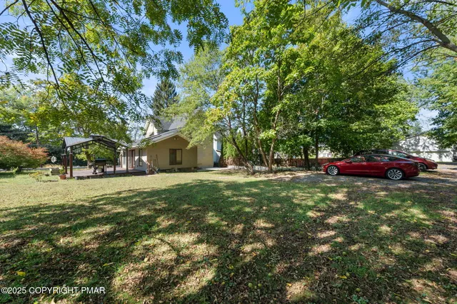 a view of outdoor space with deck and yard