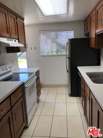 a kitchen with stainless steel appliances a sink and a refrigerator