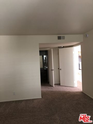a bathroom with a granite countertop shower and a sink