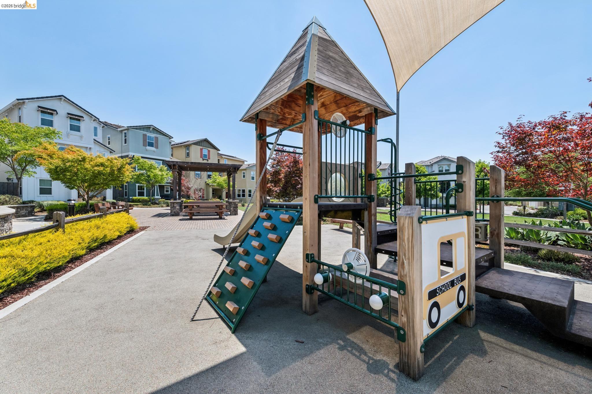 24157 Amaranth Loop Hayward, CA 94541 - Photo 61 of 63 Community playground featuring a multi-level play structure, slide, rock climbing wall, and shade sail