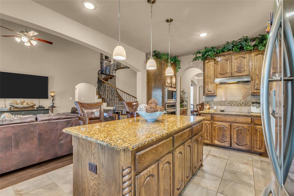 100 Spruce Street Red Oak, TX 75154 - Photo 13 of 32 a large kitchen with kitchen island a large counter space appliances and cabinets