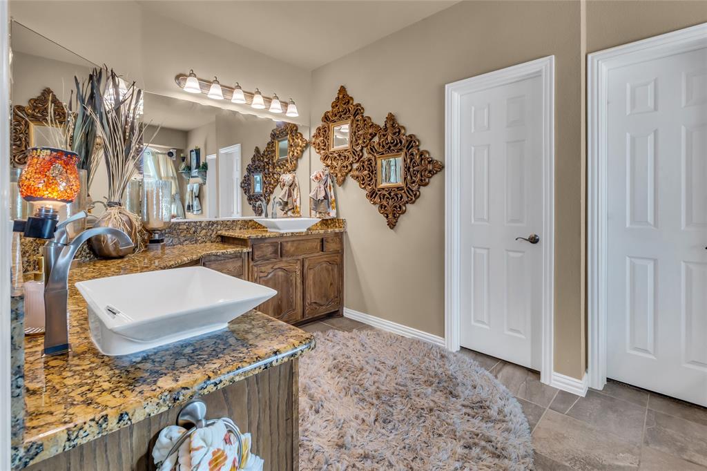 100 Spruce Street Red Oak, TX 75154 - Photo 17 of 32 a room with stainless steel appliances kitchen island granite countertop furniture a rug and a window