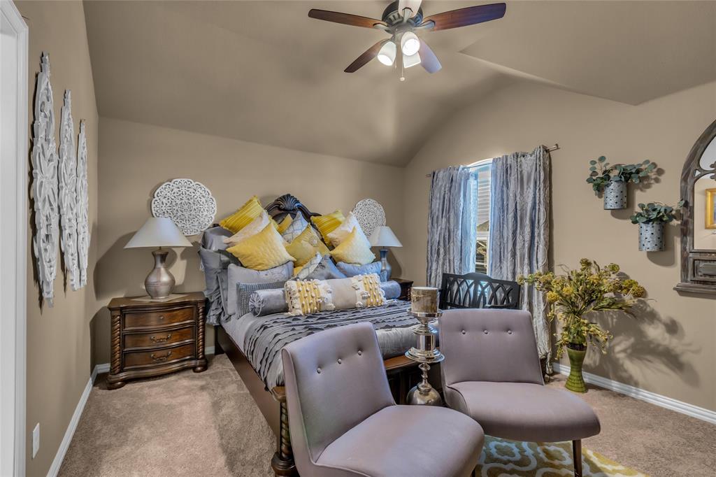 100 Spruce Street Red Oak, TX 75154 - Photo 23 of 32 a bed room with furniture and a chandelier
