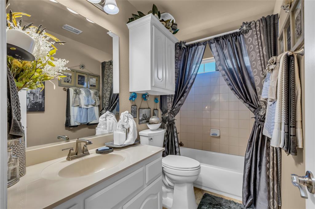 100 Spruce Street Red Oak, TX 75154 - Photo 25 of 32 a bathroom with a sink a toilet and a mirror