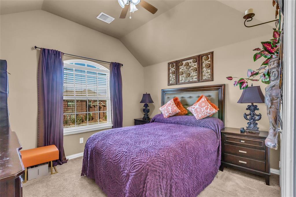 100 Spruce Street Red Oak, TX 75154 - Photo 26 of 32 a bedroom with a bed and a painting on the wall