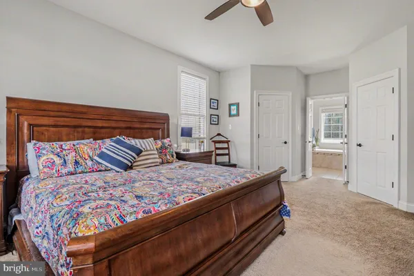 a bedroom with a bed and cabinet