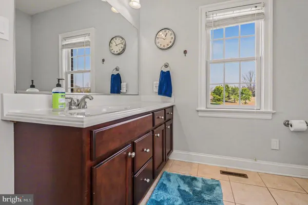 a bathroom with a sink a vanity and a mirror