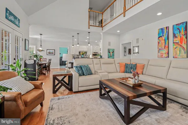 a living room with furniture a rug and a kitchen view