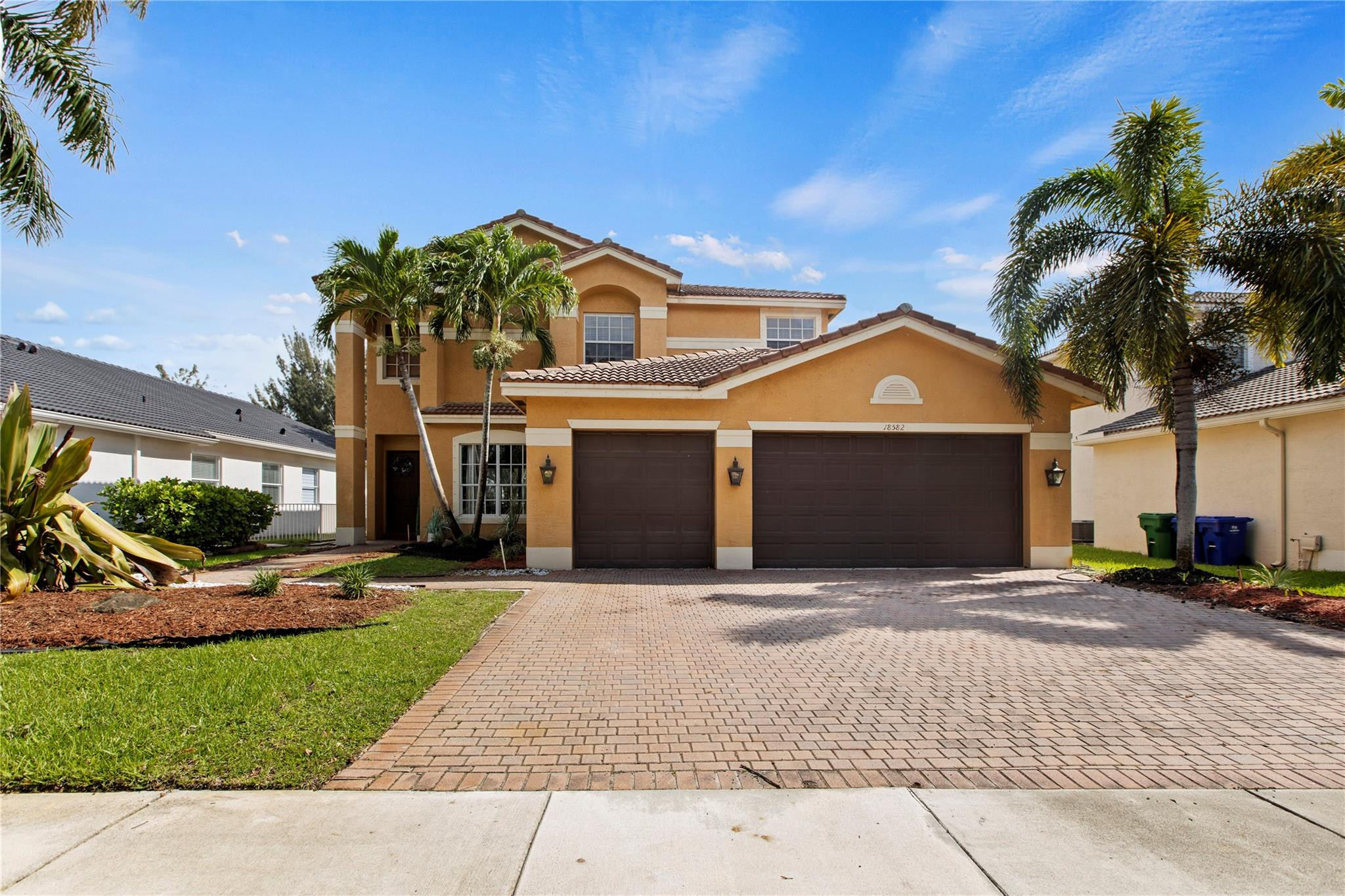 Undisclosed Address Miramar, FL 33029 - Photo 26 of 30 a front view of a house with a garden and a yard