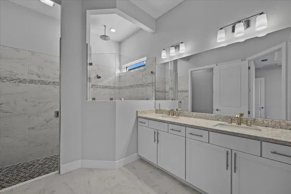 a bathroom with a granite countertop sink mirror and double