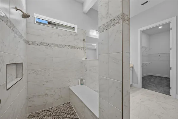 a bathroom with a shower and a sink