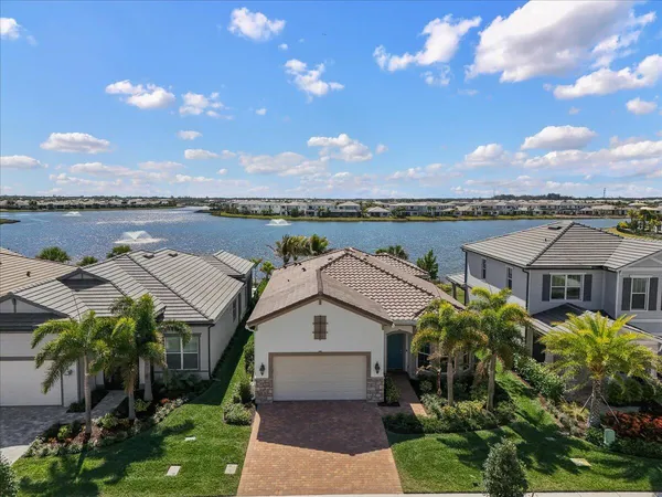 a view of a house with yard and lake view