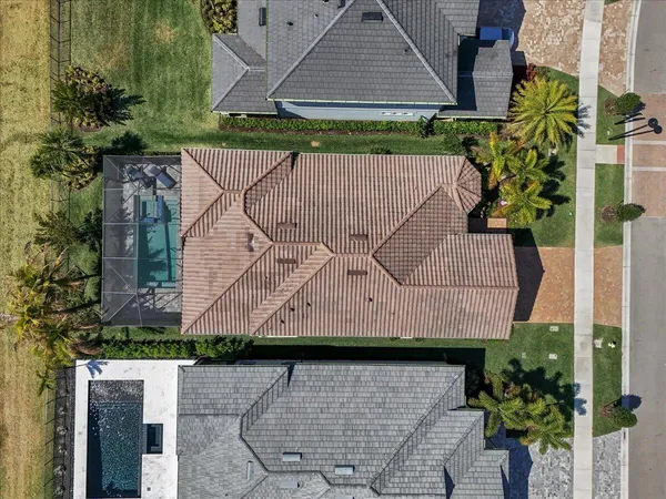 a view of a brick house with a wooden fence