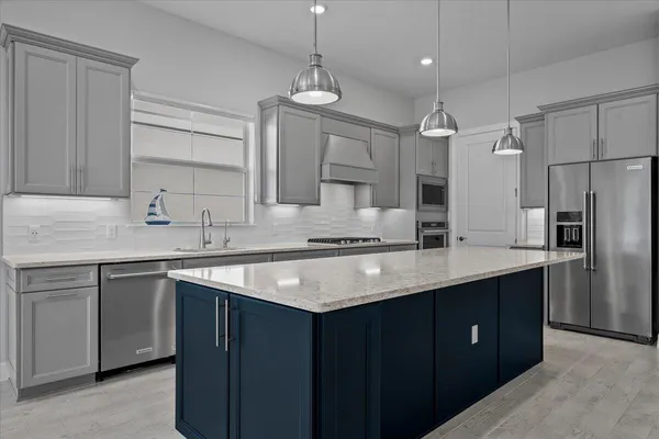 a kitchen with a sink stove and refrigerator