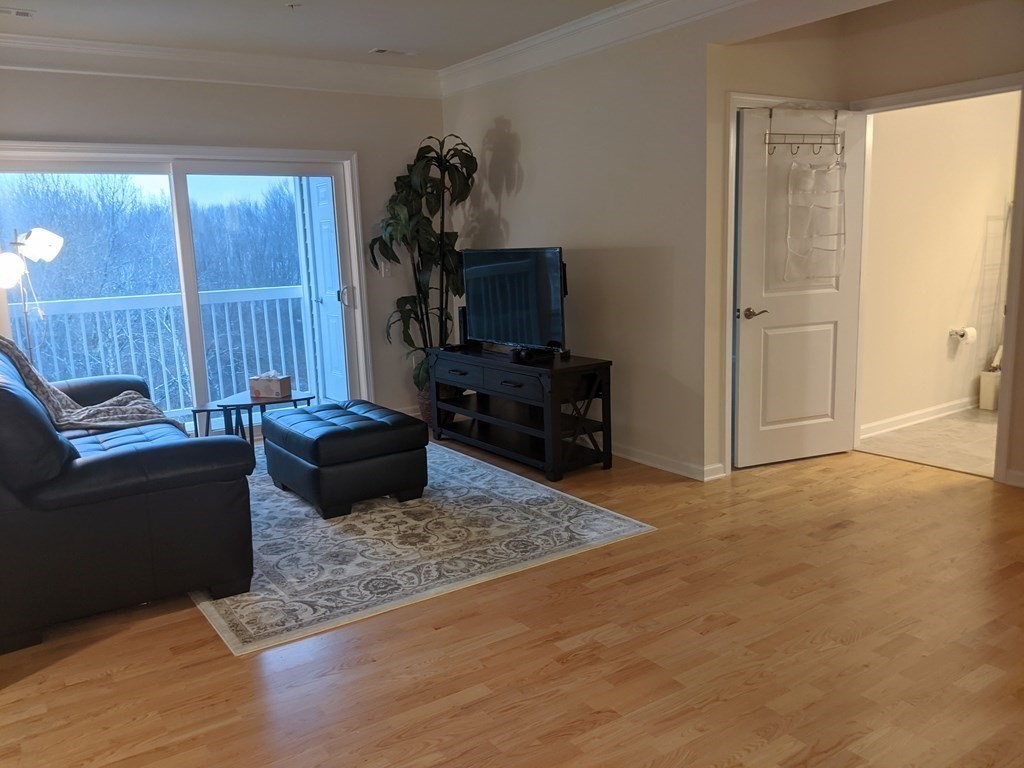 70 Trotter Road, Unit 312 Weymouth, MA 02190 - Photo 10 of 18 a living room with furniture and a flat screen tv