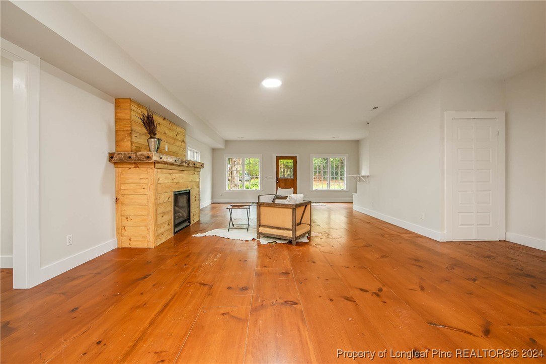 222 Goodwill Road Southern Pines, NC 28387 - Photo 11 of 49 a living room with furniture and a fireplace