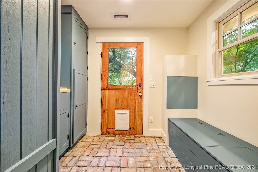 222 Goodwill Road Southern Pines, NC 28387 - Photo 13 of 49 a hallway with sliding door and wooden floor