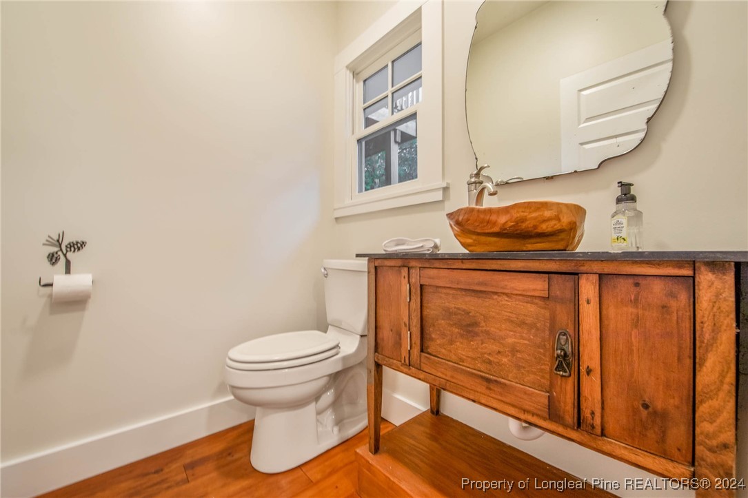 222 Goodwill Road Southern Pines, NC 28387 - Photo 14 of 49 a bathroom with a toilet and a mirror