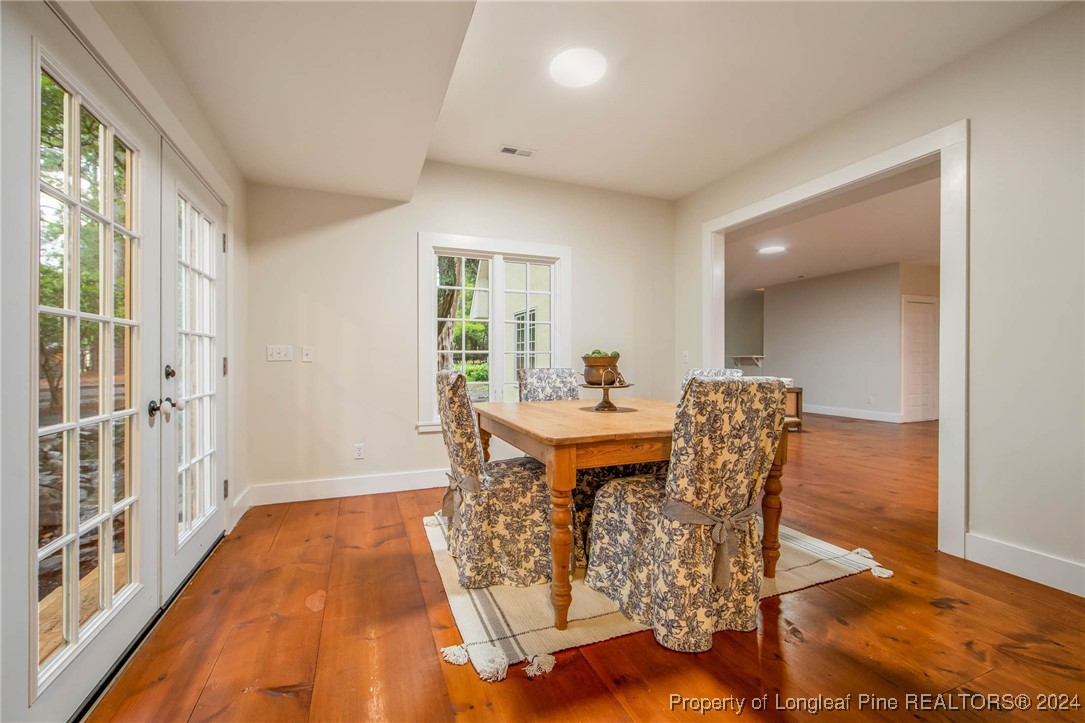 222 Goodwill Road Southern Pines, NC 28387 - Photo 15 of 49 a dining room with furniture and wooden floor