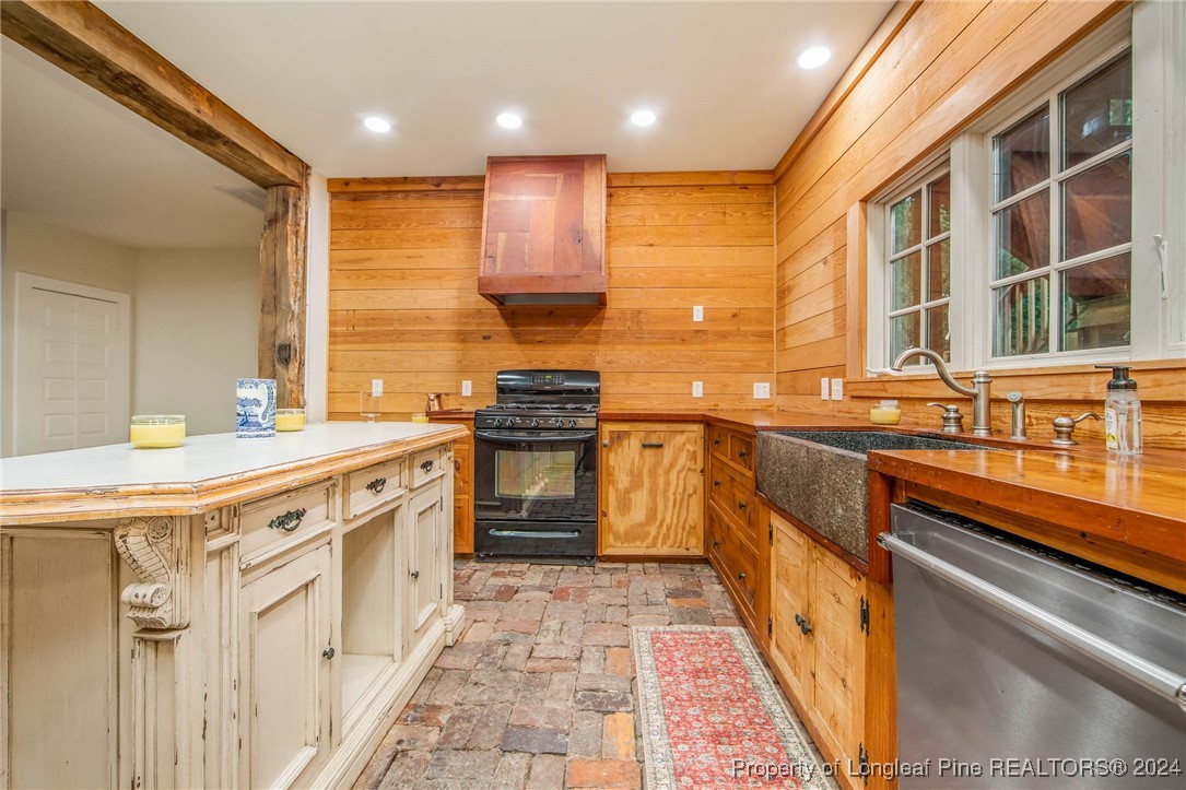 222 Goodwill Road Southern Pines, NC 28387 - Photo 17 of 49 a kitchen with stainless steel appliances granite countertop a sink and a stove