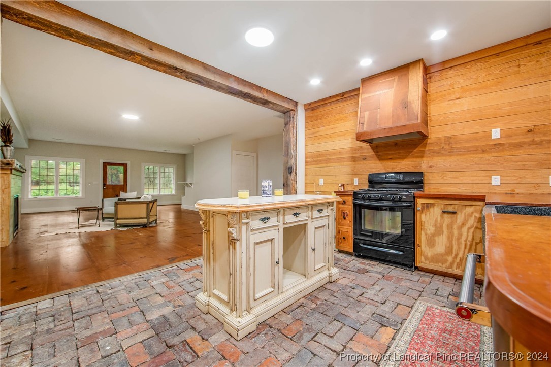 222 Goodwill Road Southern Pines, NC 28387 - Photo 18 of 49 a kitchen with stainless steel appliances granite countertop a stove a sink and a microwave