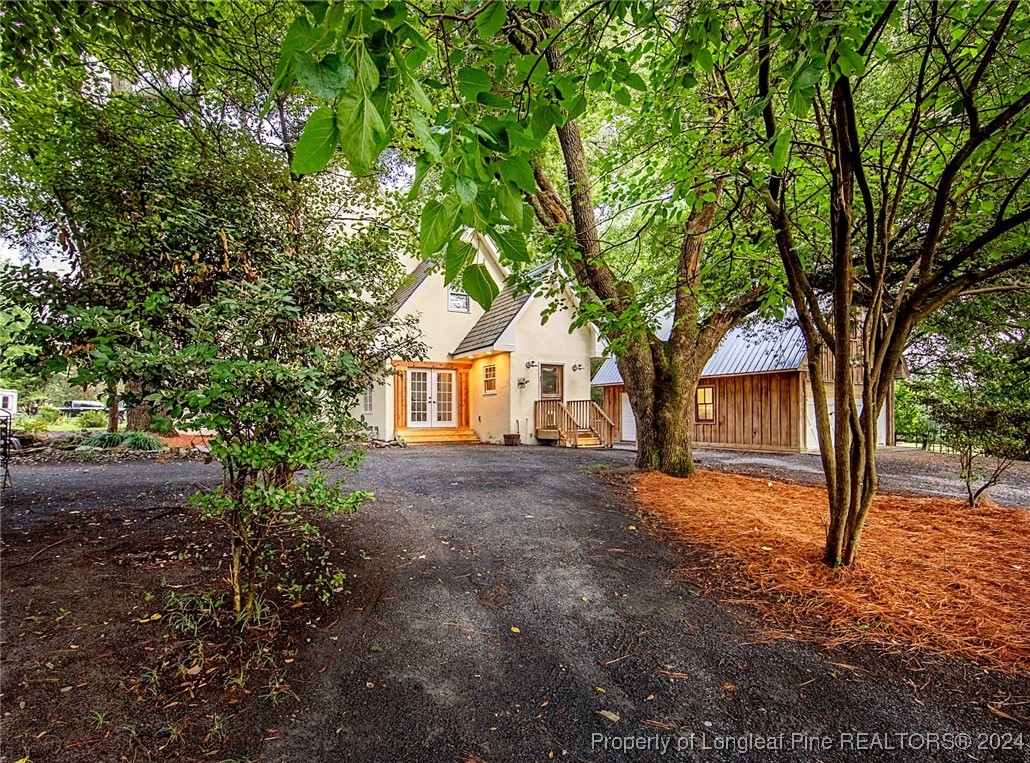 222 Goodwill Road Southern Pines, NC 28387 - Photo 2 of 49 a view of a house with a tree