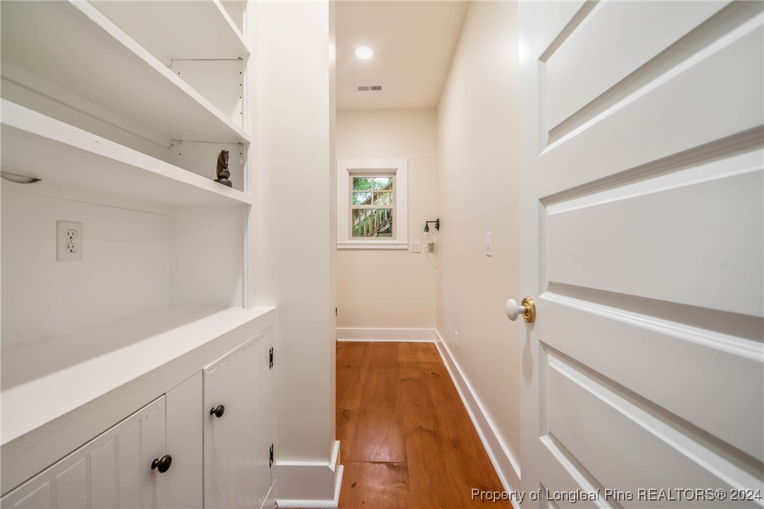 222 Goodwill Road Southern Pines, NC 28387 - Photo 23 of 49 a view of a hallway with wooden floor and staircase