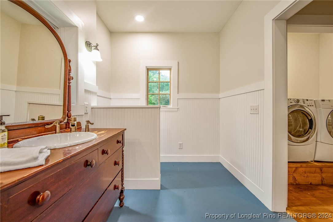 222 Goodwill Road Southern Pines, NC 28387 - Photo 25 of 49 a bathroom with a sink and a mirror